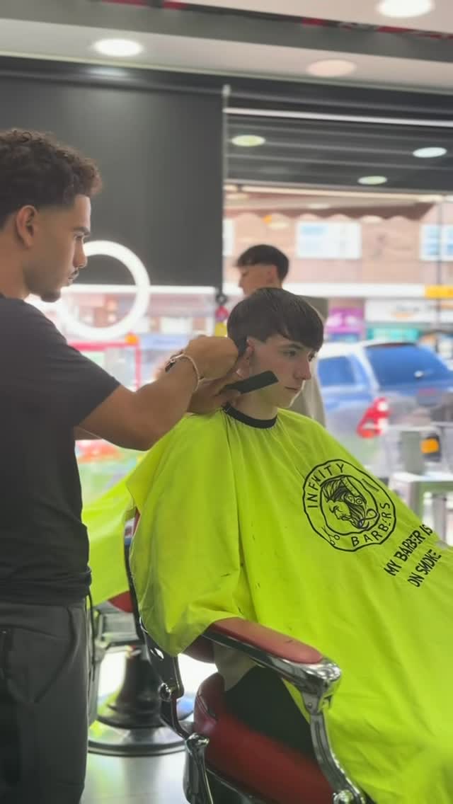 A fade taking shape mid-cut at Infinity Barbers