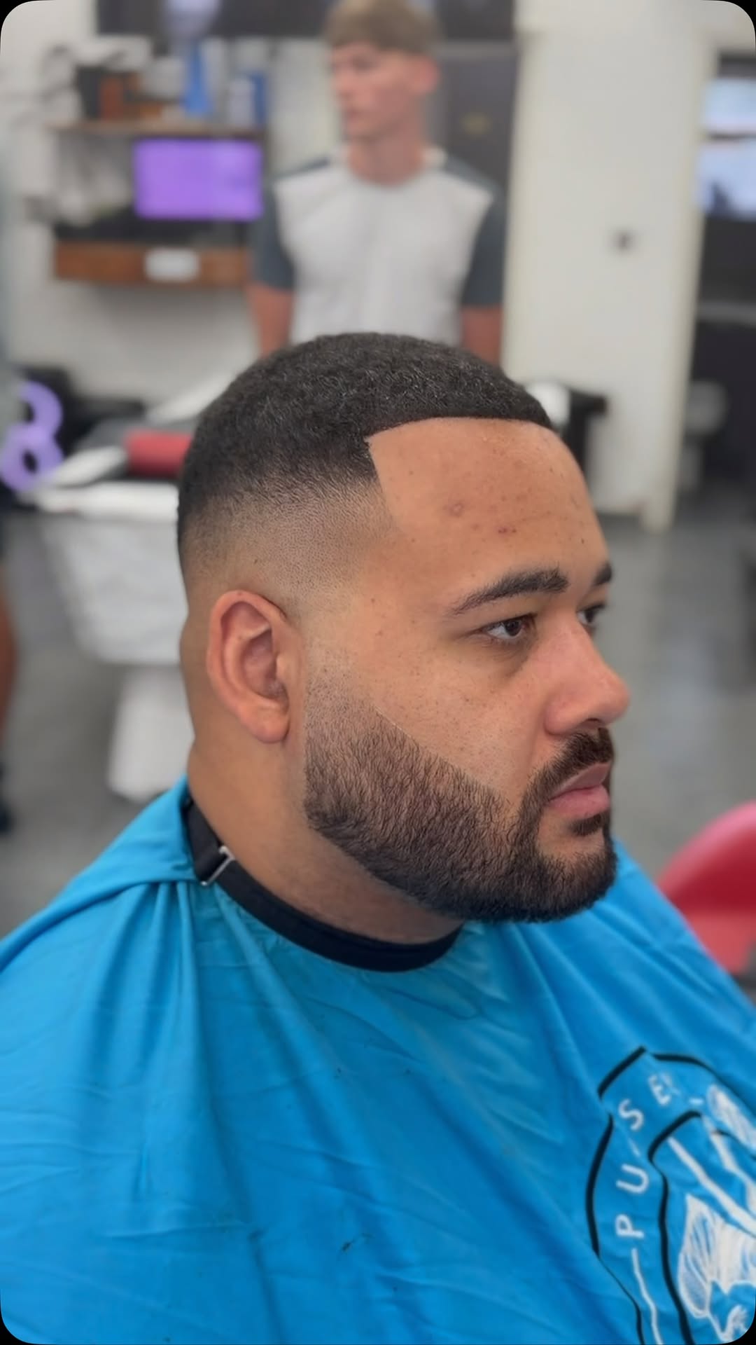 A skin fade and beard shape-up finished at Infinity Barbers